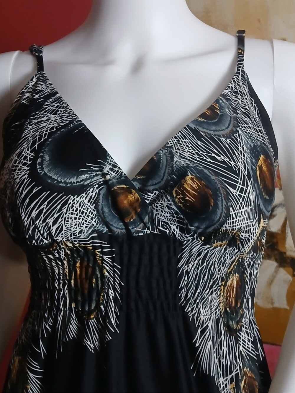 sleeveless maxi dress features a smocked empire waist and a striking black